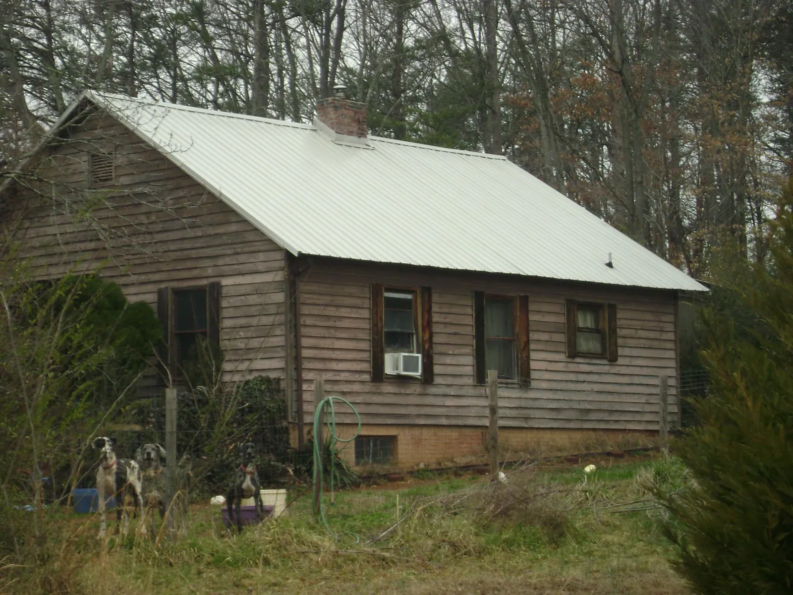 White metal roof on an old wood sided farmhouse, from a Metal Roof Installation job in Glen Allen